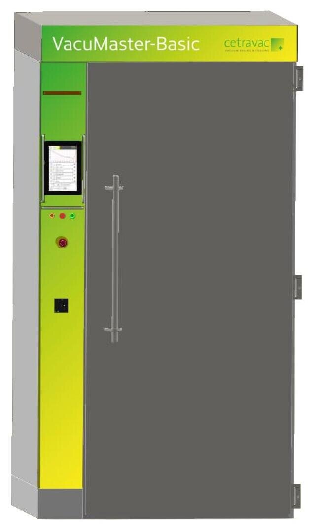 Eine große, aufrechte Industriemaschine mit der Bezeichnung VacuMaster-Basic mit einem grün-gelben Bedienfeld, einer Digitalanzeige, Knöpfen und einer hohen, grauen Tür mit einem vertikalen Griff.