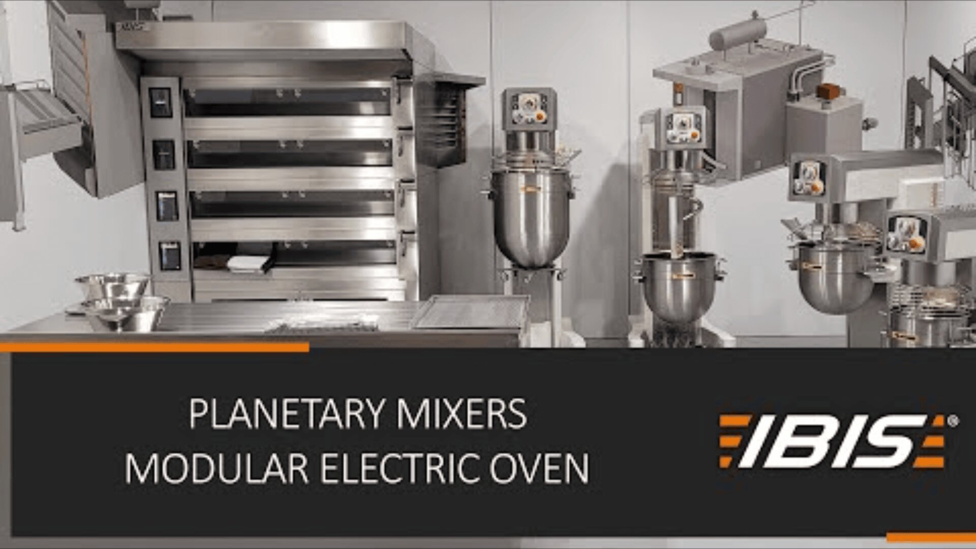 Commercial kitchen featuring large stainless steel planetary mixers and a modular electric oven. Control panels are visible on each machine. The text reads: PLANETARY MIXERS MODULAR ELECTRIC OVEN IBIS.