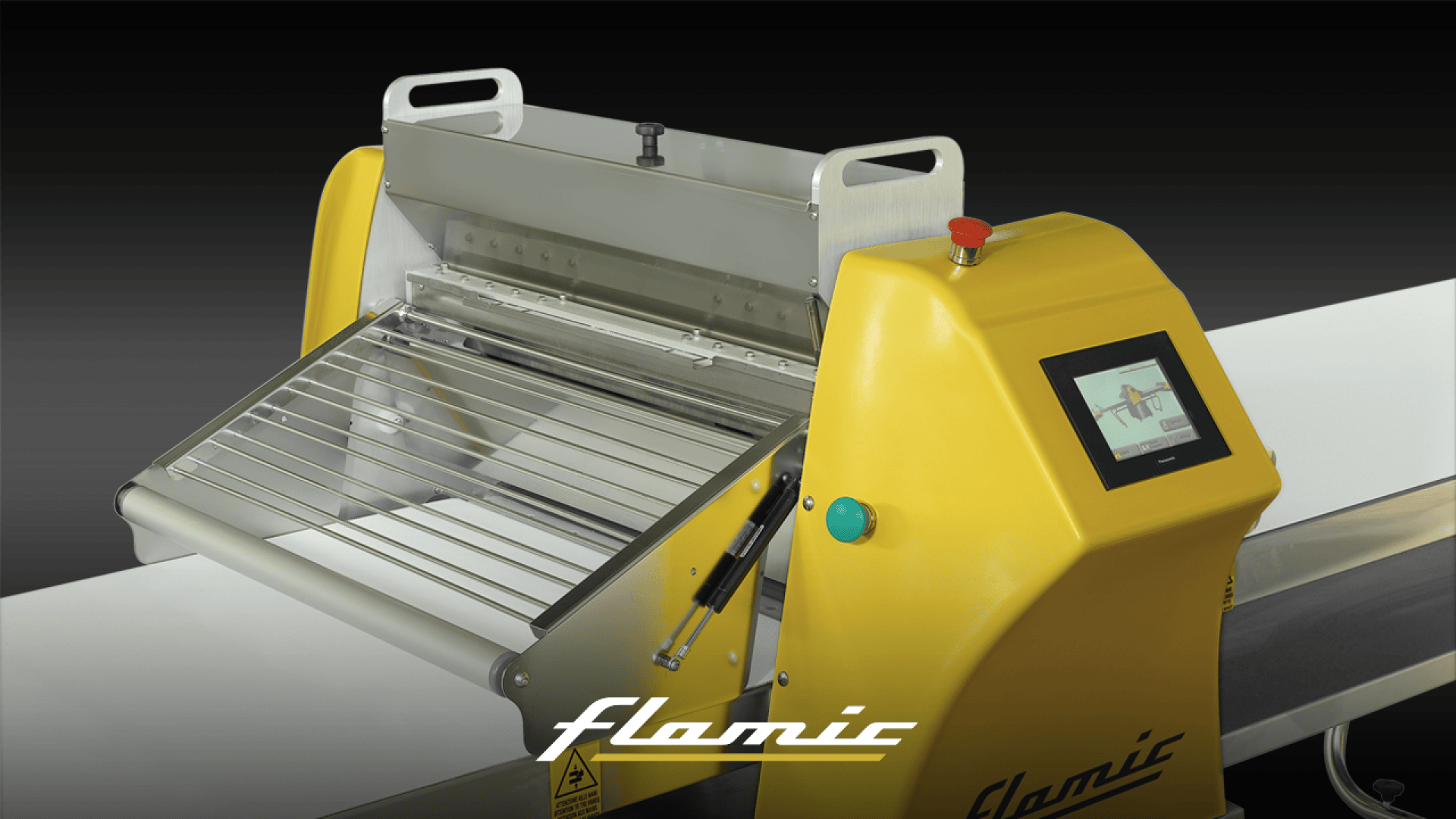 A yellow and silver industrial food processing machine with a touchscreen display, stainless steel grates, and the Flamic logo, set against a dark background.
