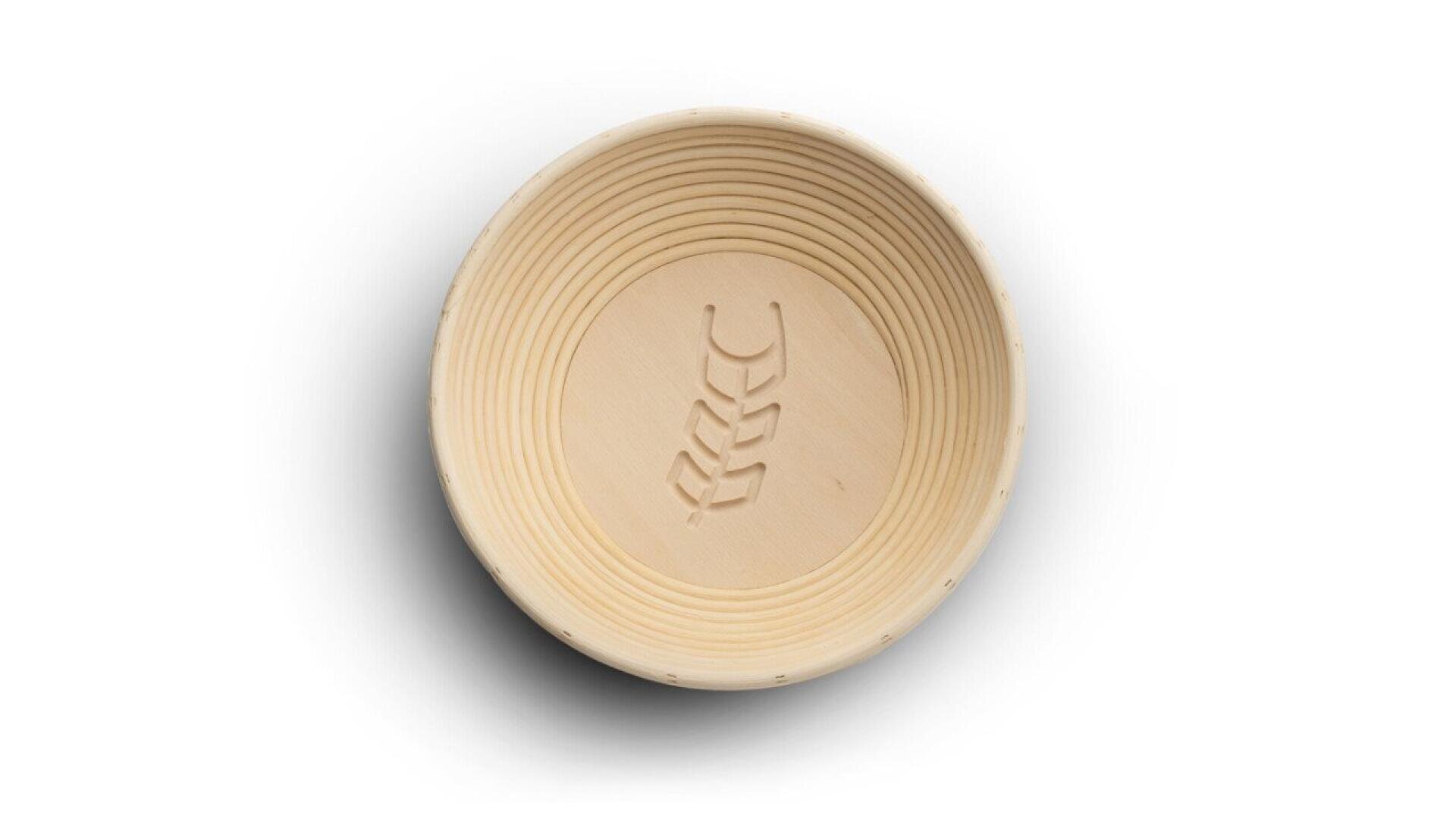 A round, light-colored wooden bowl with concentric grooves along the inner sides and a wheat design carved in the center, viewed from above against a white background.