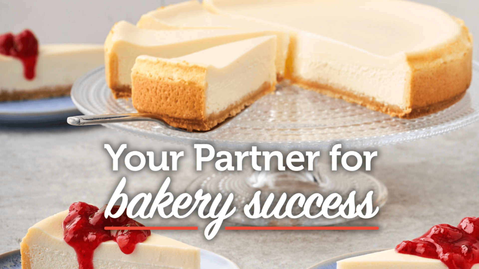 A creamy cheesecake on a glass stand is sliced, with plates of cheesecake topped with cherry sauce in the background. Text overlay reads, Your Partner for bakery success.