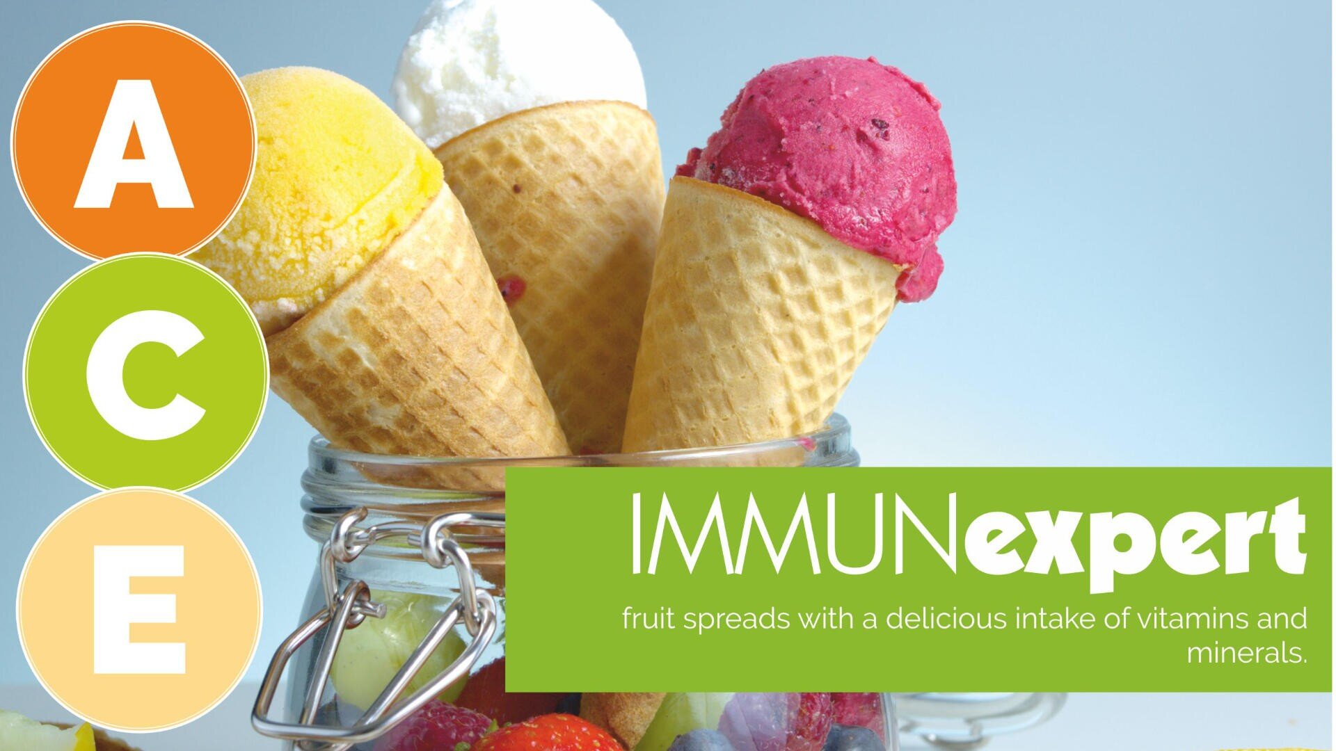 A glass jar holds three ice cream cones in yellow, white, and red. On the left, circles with A, C, and E are stacked vertically. The text reads: IMMUNexpert fruit spreads with a delicious intake of vitamins and minerals.
