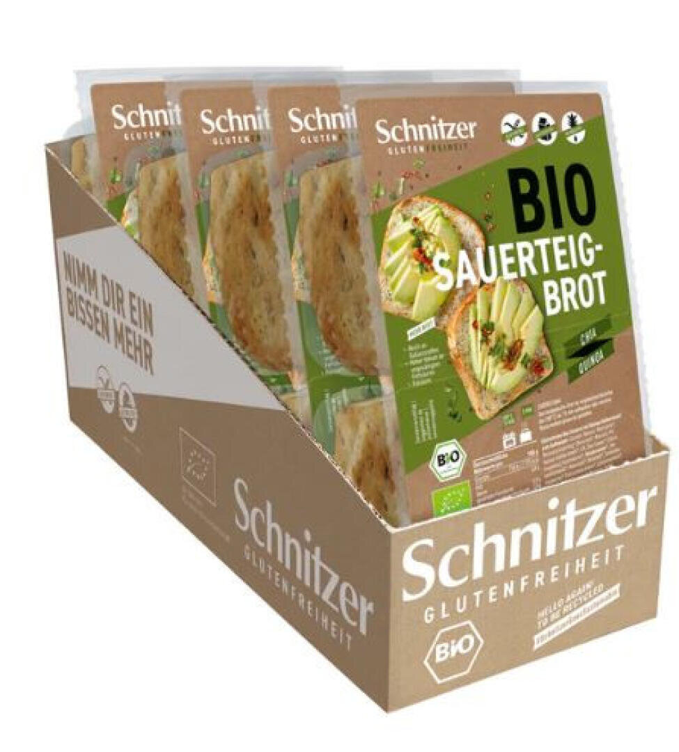 Eine Pappschachtel mit glutenfreiem Sauerteigbrot von Schnitzer Bio, auf der mehrere Packungen mit grünem Etikett abgebildet sind, auf denen geschnittenes Brot mit Kräutern und Gemüse zu sehen ist.