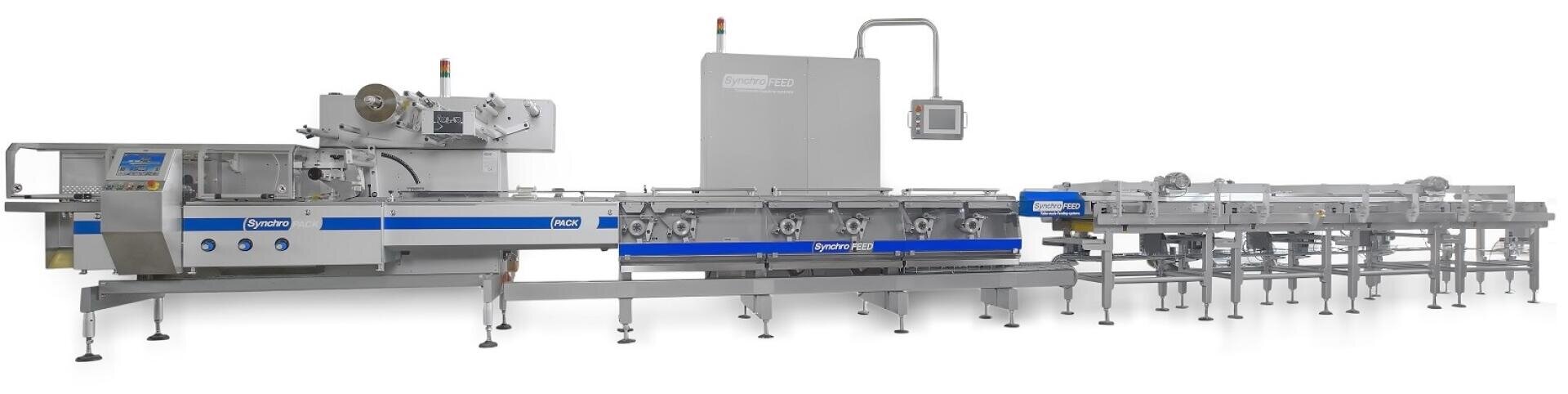 A large industrial food packaging machine with conveyor belts, stainless steel components, control panels, and a touchscreen monitor in a modern factory setting.