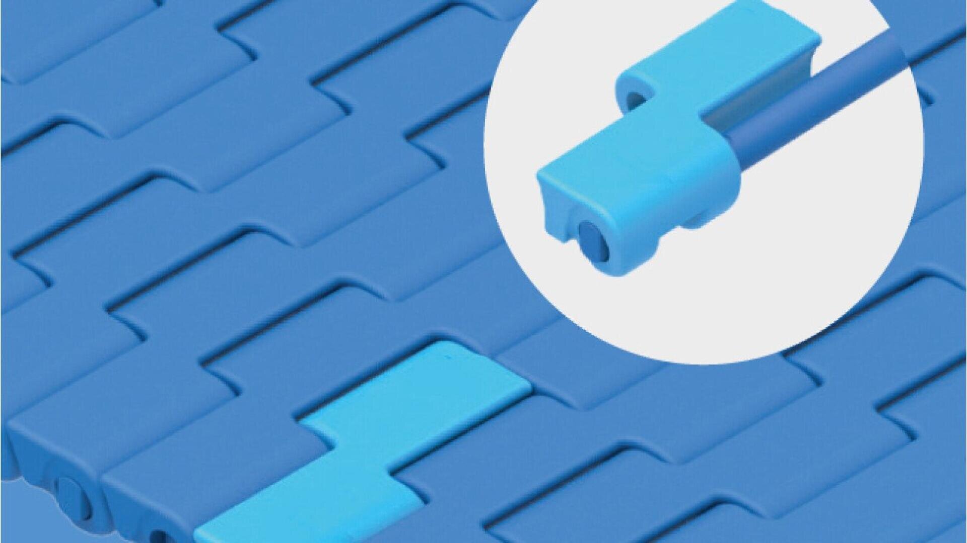 Close-up of interlocking blue plastic tiles, with one lighter blue tile highlighted in a circular inset showing its connector detail and grooved design.