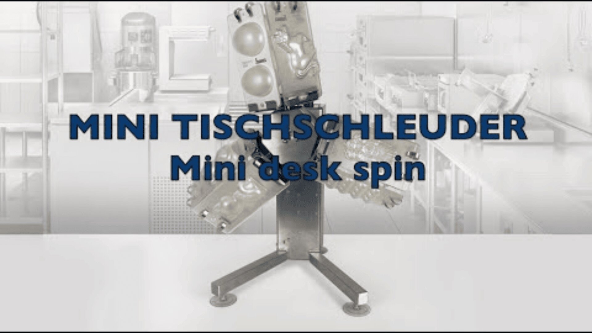 A metal mini centrifuge is displayed in a laboratory with the text MINI TISCHSCHLEUDER and Mini desk spin overlaid on the image.
