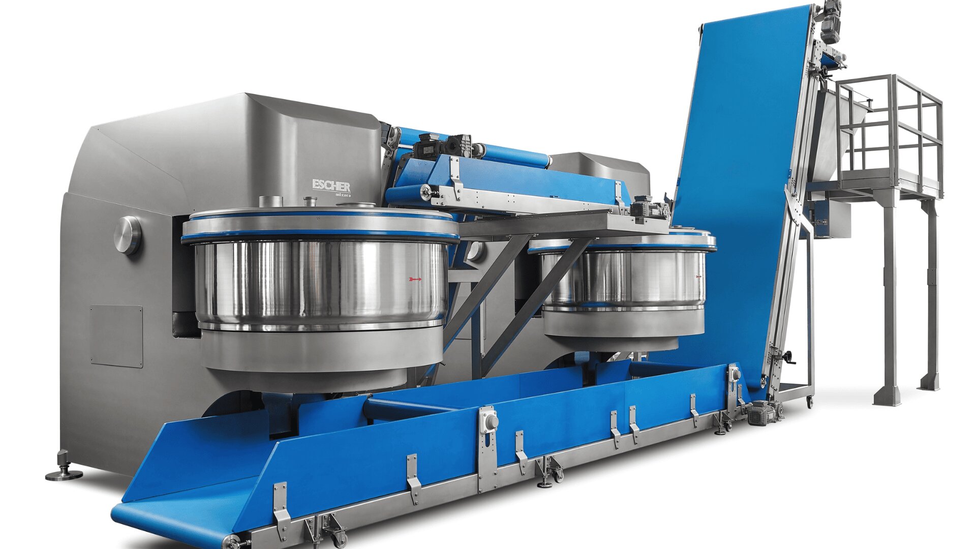 A large industrial food processing machine with two circular stainless steel mixing bowls, blue conveyor sections, and a metal platform with stairs on the right side.