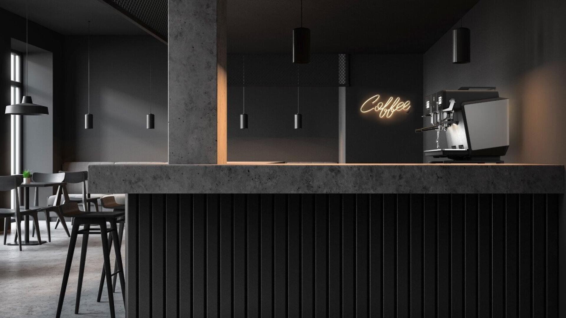 A modern, minimalist coffee shop interior with dark walls and furniture, a concrete counter, pendant lights, and a coffee machine. A neon sign reading Coffee is illuminated on the back wall.