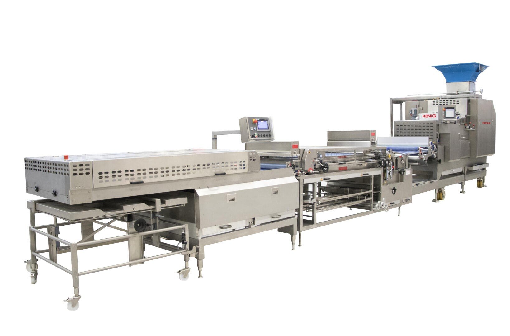Large industrial food processing machine with multiple stainless steel sections, conveyor belts, control panels, and a blue hopper, designed for automated production, standing on wheels for mobility.