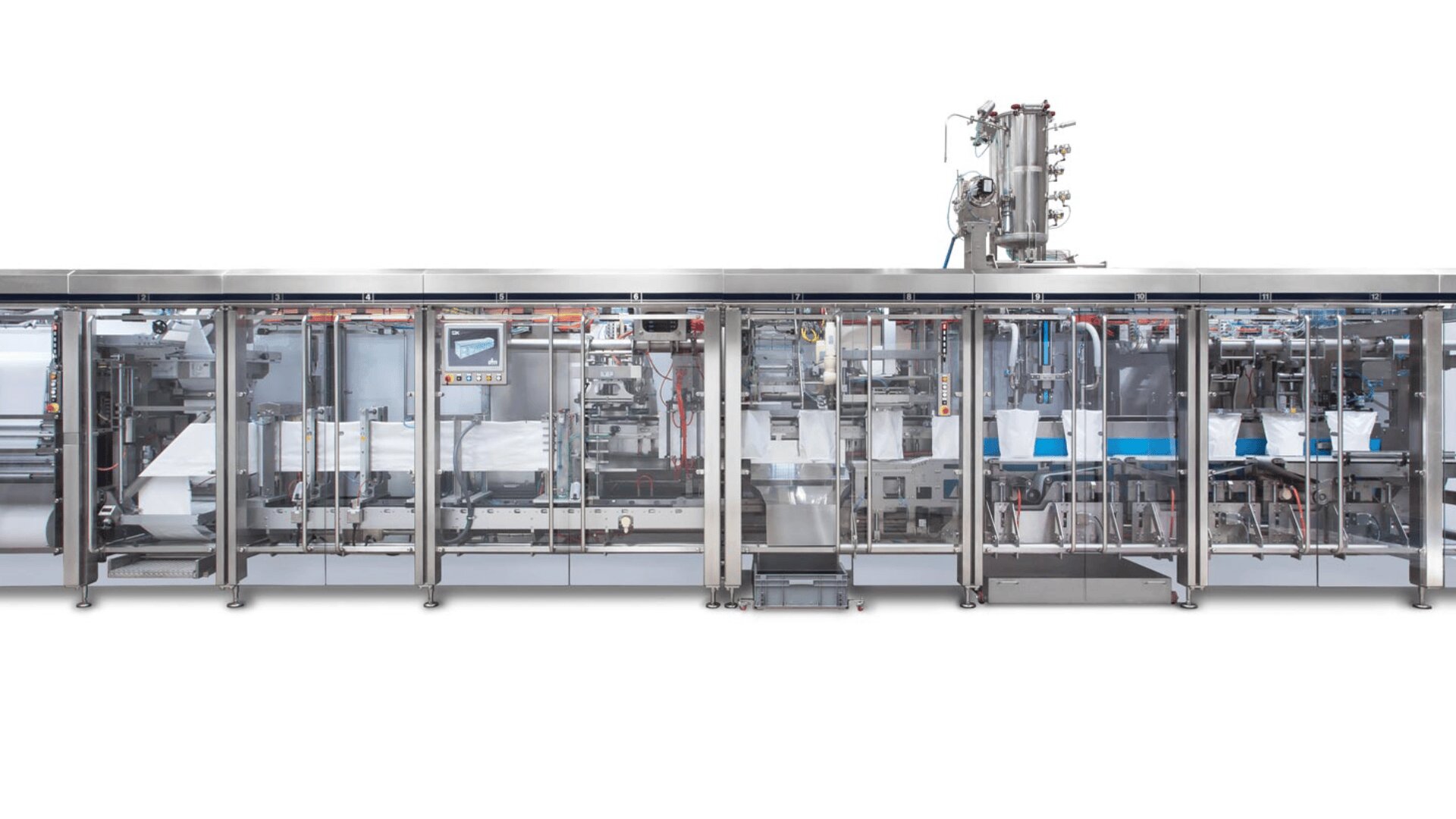 A large, automated industrial packaging machine with transparent panels showing internal components and conveyor belts, designed for high-speed production in a clean, modern facility, against a white background.