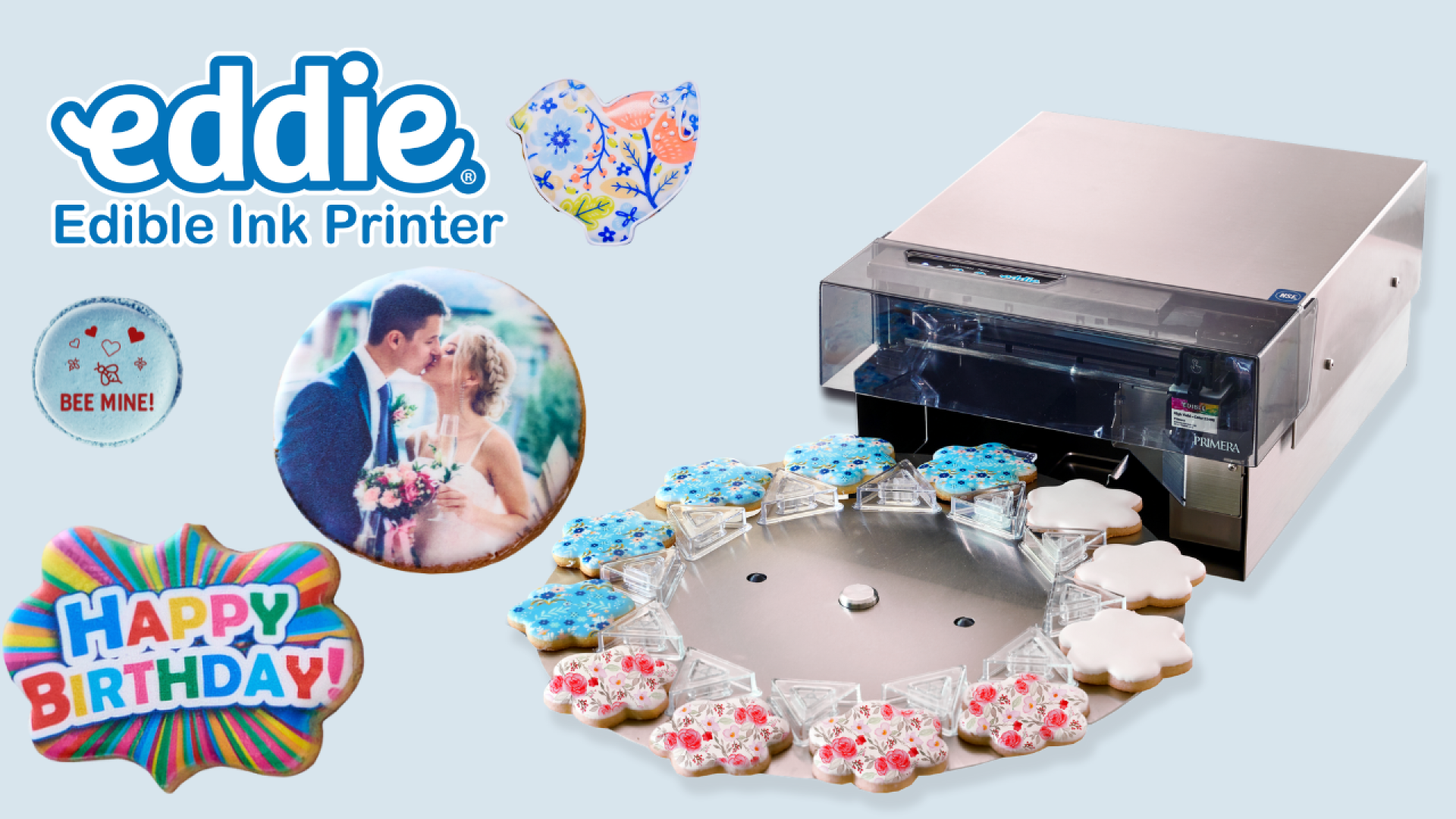 Edible ink printer with decorated cookies and edible prints, including a floral heart, a wedding photo, “Bee Mine!” message, and “Happy Birthday” text, demonstrating custom food printing.