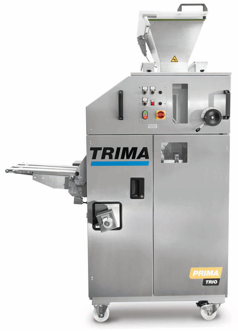 Industrielle Brötchentrenn- und Abrundungsmaschine mit der Bezeichnung TRIMA PRIMA TRIO, mit einem Trichter auf der Oberseite, Steuertasten und Rädern für die Mobilität, für den Einsatz in Bäckereien.