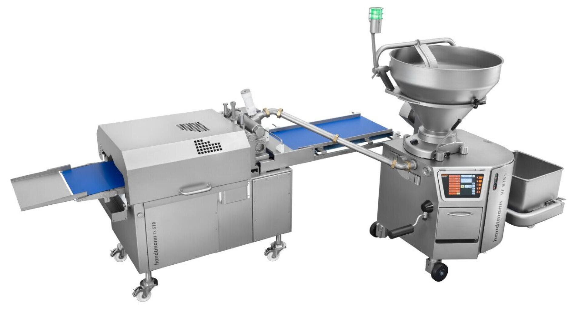 Industrial food processing machine with a control panel, large mixing bowl on one side, connected to a conveyor system and enclosed section, likely used for dough or meat processing.