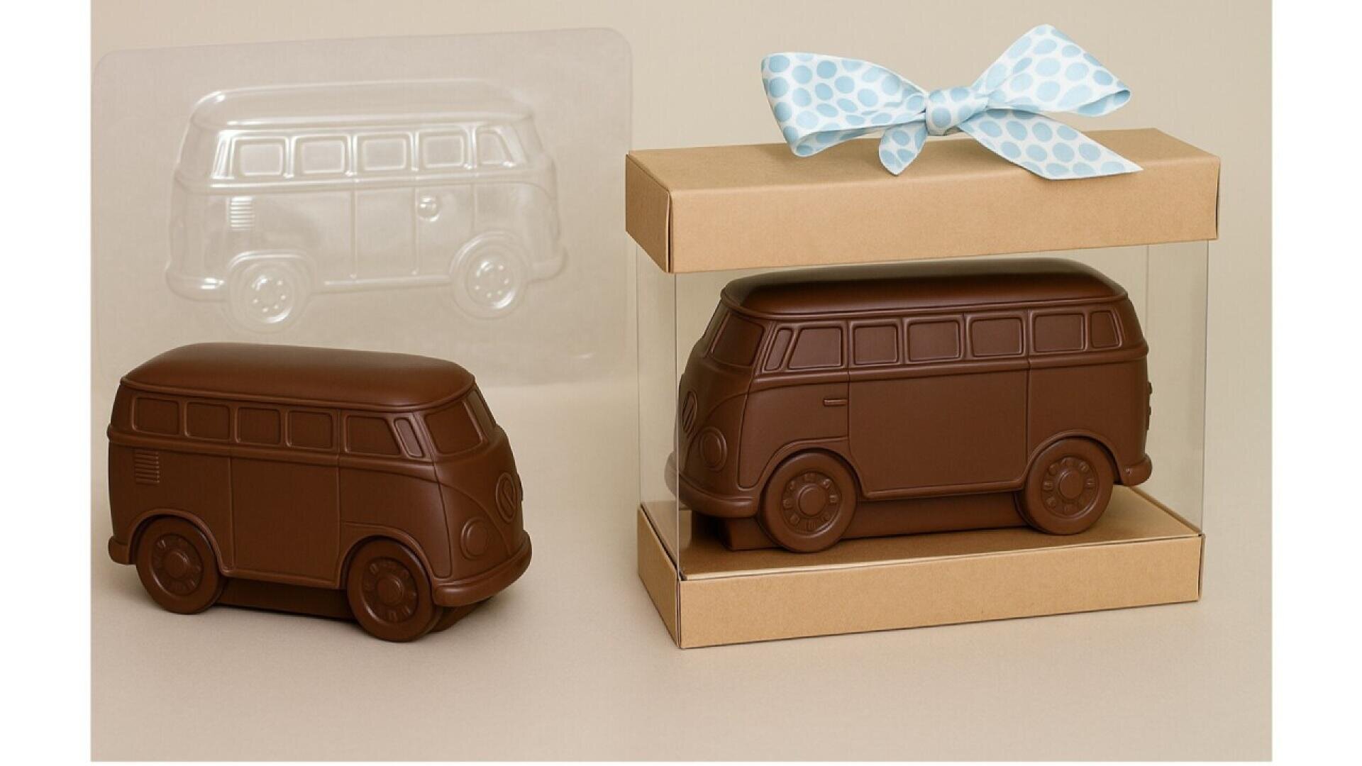A chocolate shaped like a classic van is displayed next to its clear plastic mold and packaged in a box with a blue polka dot ribbon on top.