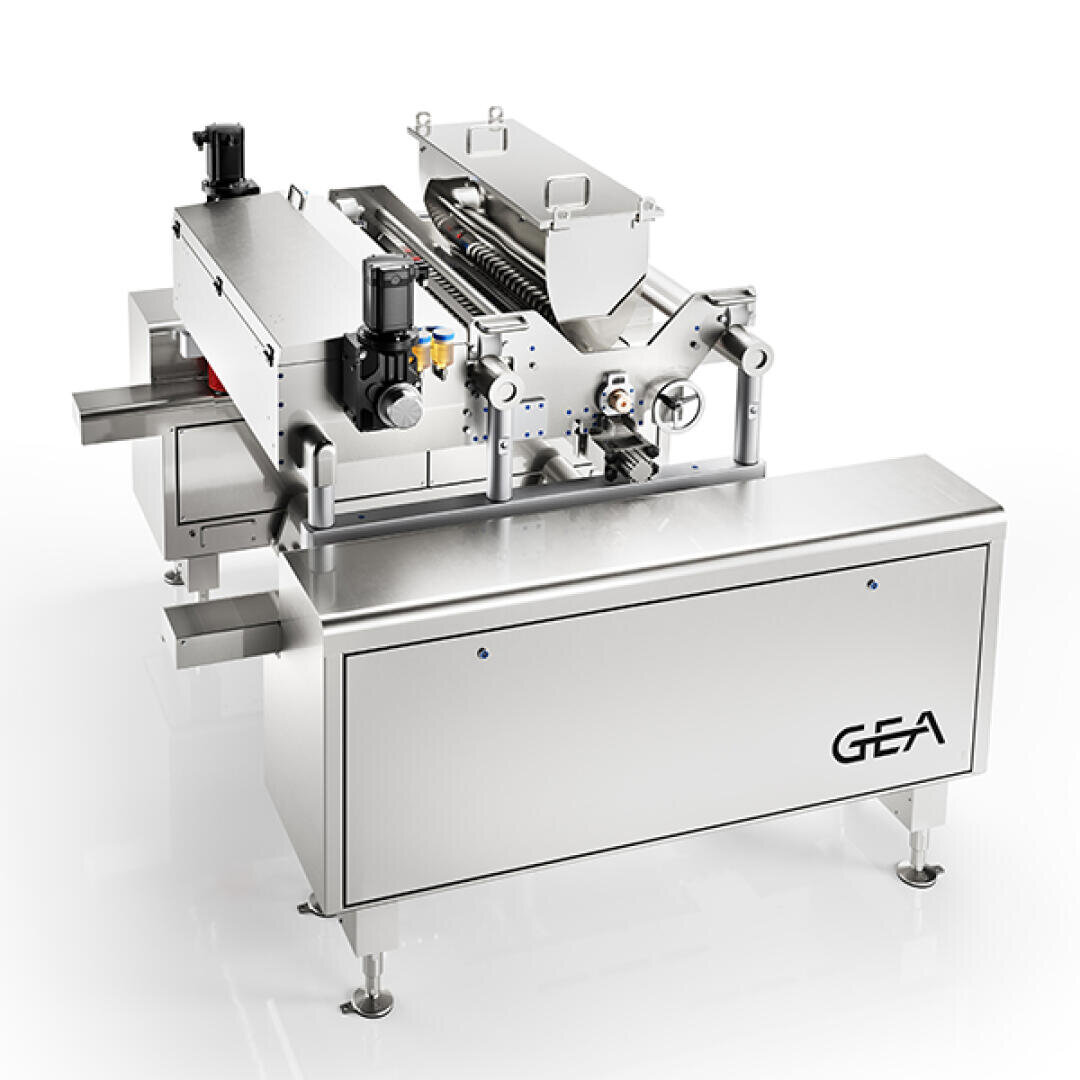 A stainless steel industrial food processing machine by GEA, featuring a conveyor system, control units, and covered components, standing on four legs against a white background.