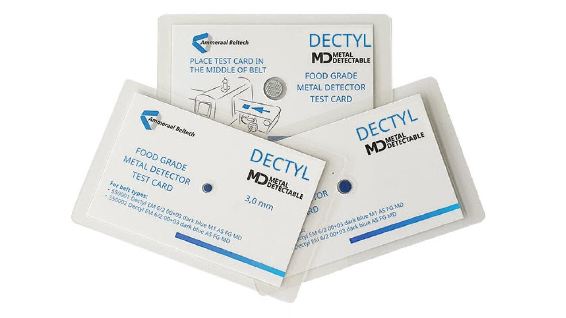 Three rectangular food-grade metal detector test cards labeled DECTYL MD Metal Detectable Test Card with manufacturer branding. One card shows placement instructions; all display details about size and specifications.