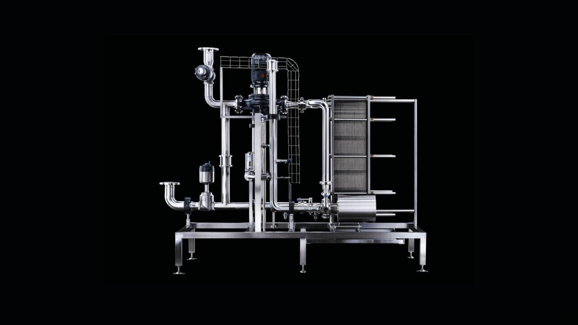 A stainless steel industrial filtration machine with interconnected pipes, valves, and a rectangular filter unit, set against a black background.