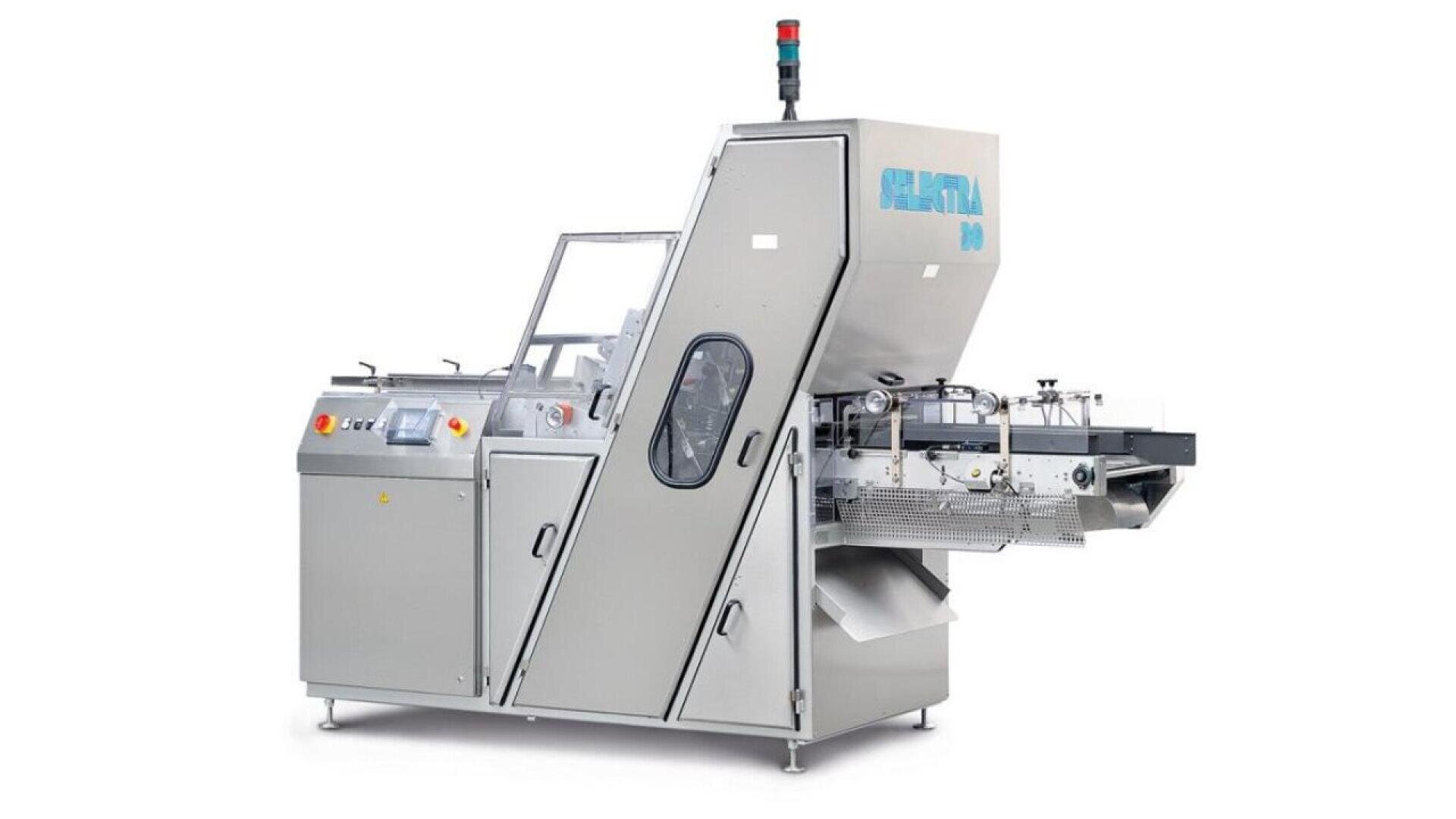 A large, silver industrial packaging machine with control panels, a transparent window, and conveyor belts, featuring the brand name “Sentina” on the upper section. A red and green indicator light sits on top.