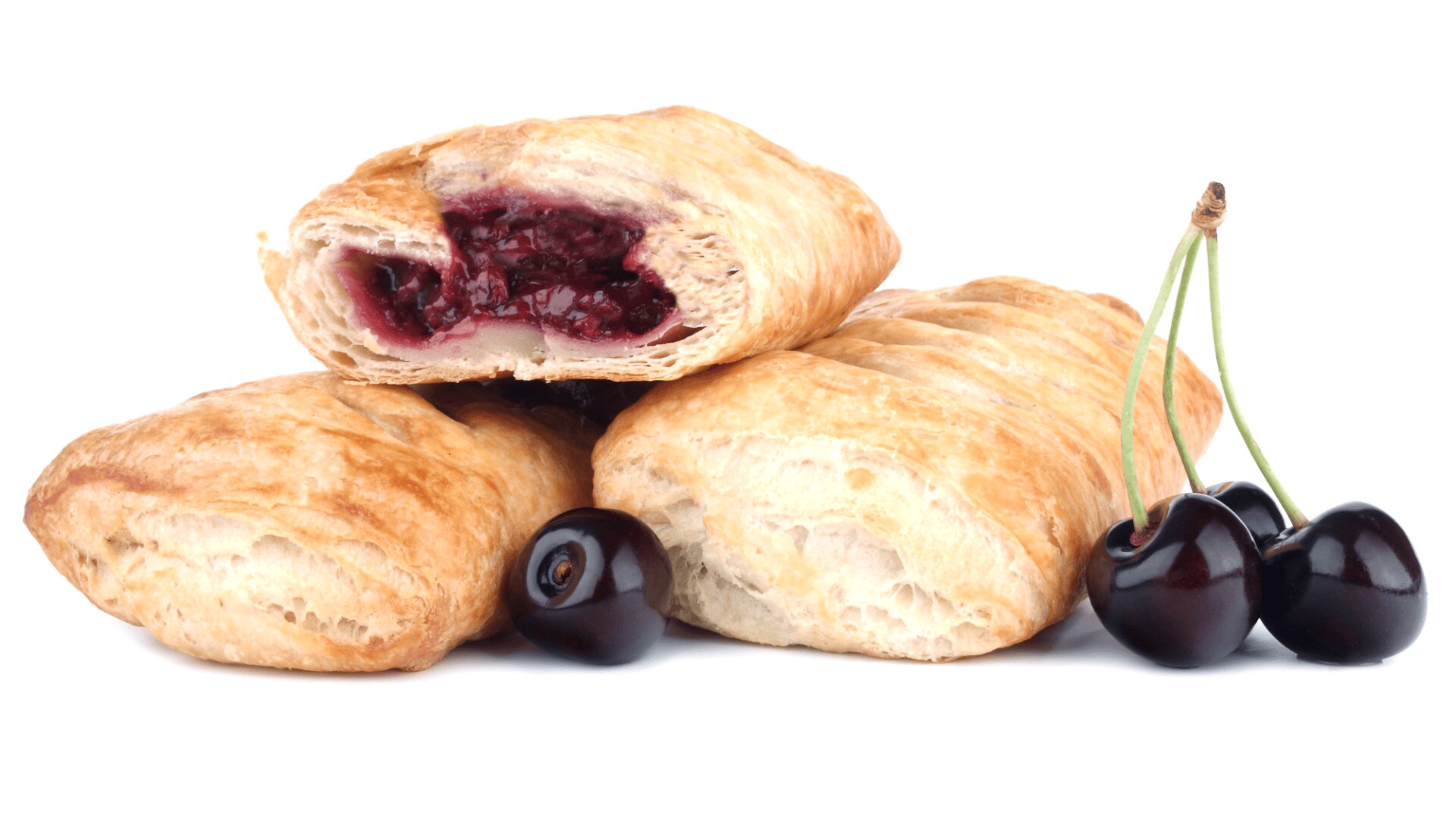 Three flaky pastries are stacked together, with one cut open to reveal a cherry filling. Whole dark cherries with stems are placed beside the pastries, all set against a white background.