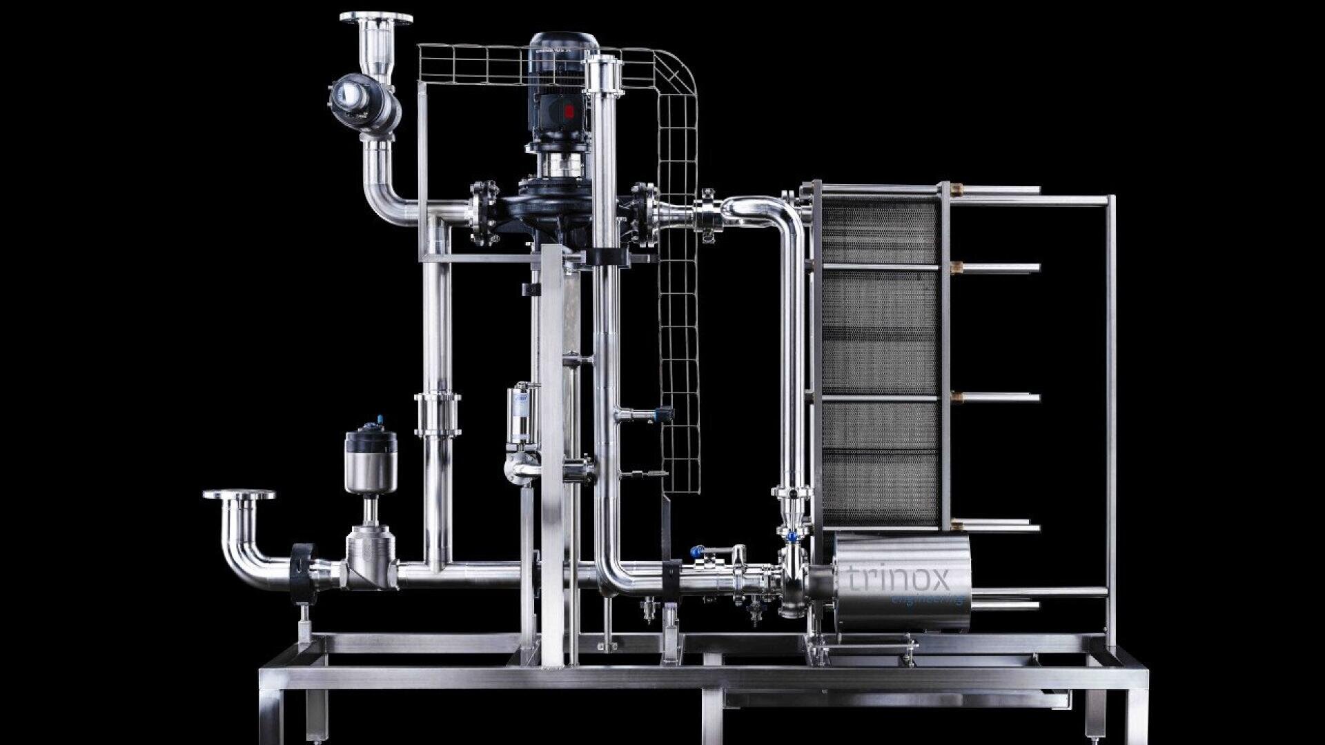 A stainless steel industrial filtration or processing system with interconnected pipes, valves, a motor, and a heat exchanger mounted on a metal frame, all set against a black background.