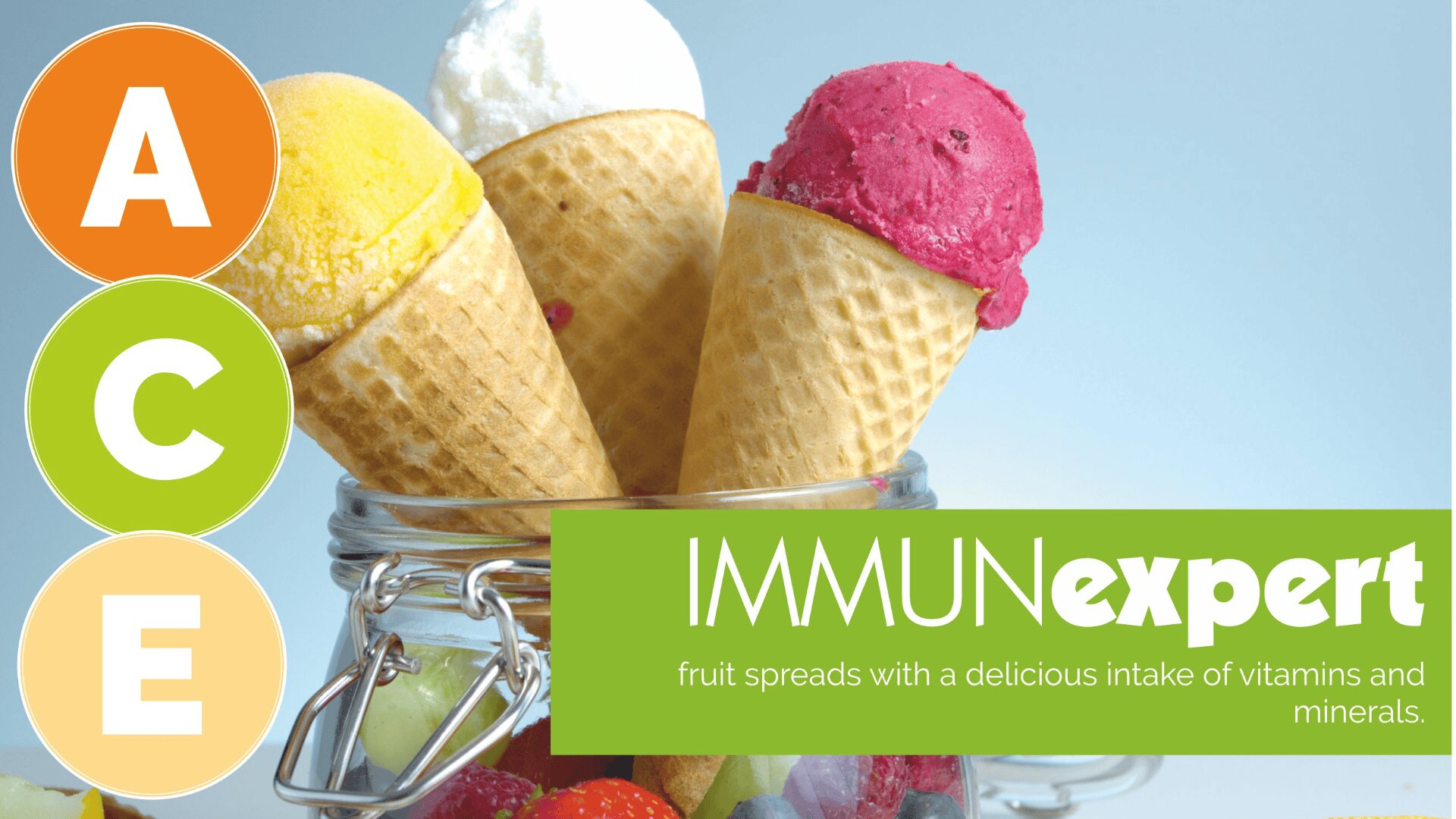 Three colorful ice cream cones in a glass jar with berries, next to large letters A, C, E in circles, and text reading IMMUNexpert: fruit spreads with a delicious intake of vitamins and minerals.