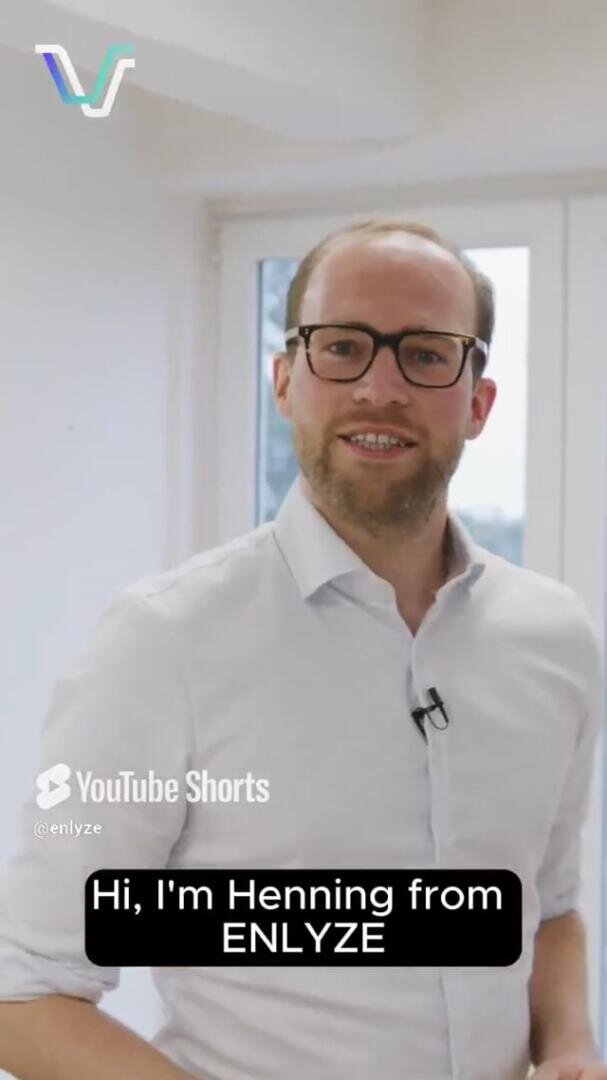 A man with glasses and a beard, wearing a white shirt, stands indoors and smiles at the camera. The text on screen reads, Hi, Im Henning from ENLYZE. The YouTube Shorts and ENLYZE logos are also visible.