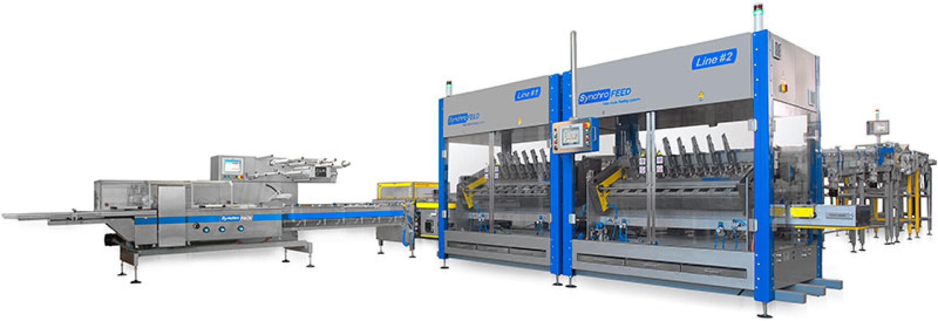 Automated industrial food processing and packaging machinery with conveyor belts, control panels, and stainless steel components, designed for sorting and packing products in a factory setting.