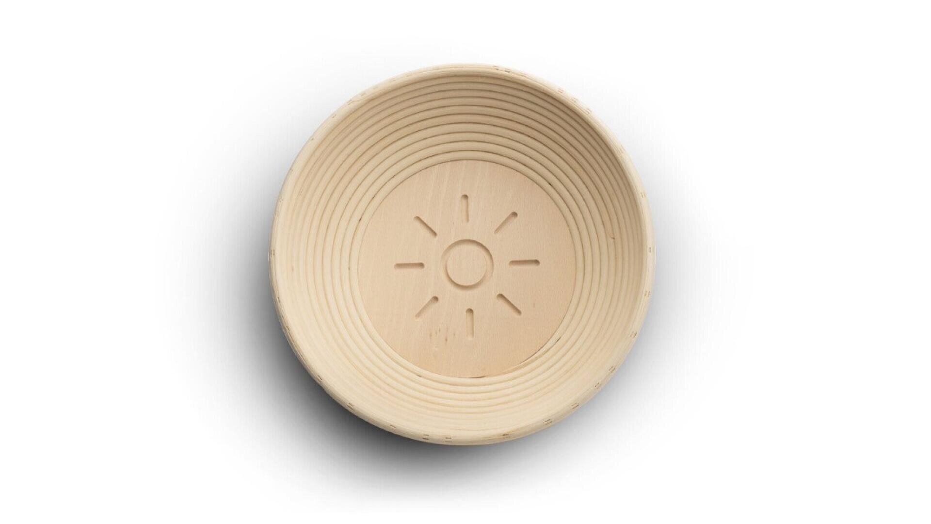 A round, light-colored wooden bowl with a sun-like pattern carved in the center and concentric grooves along the inner sides, seen from above on a white background.
