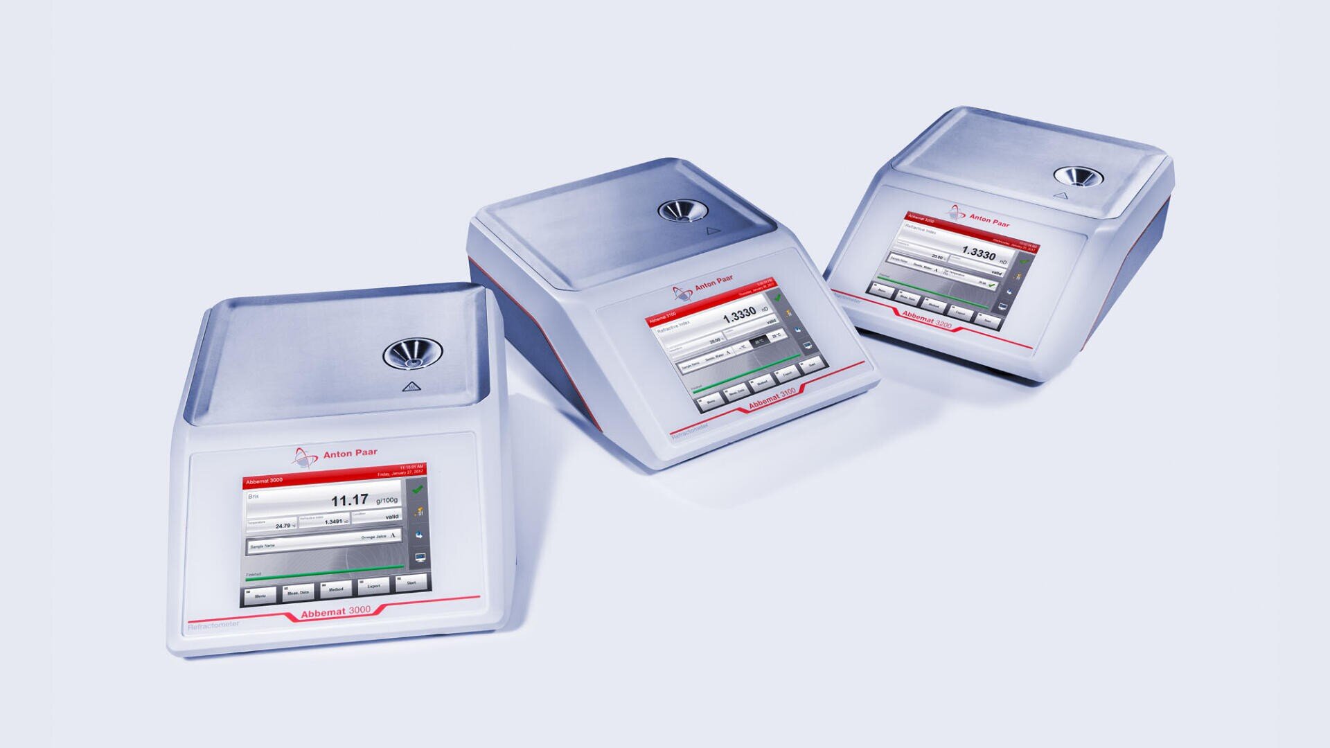 Three Anton Paar laboratory density meters with digital touchscreens are displayed side by side on a light background, showing measurement data and controls on their screens.