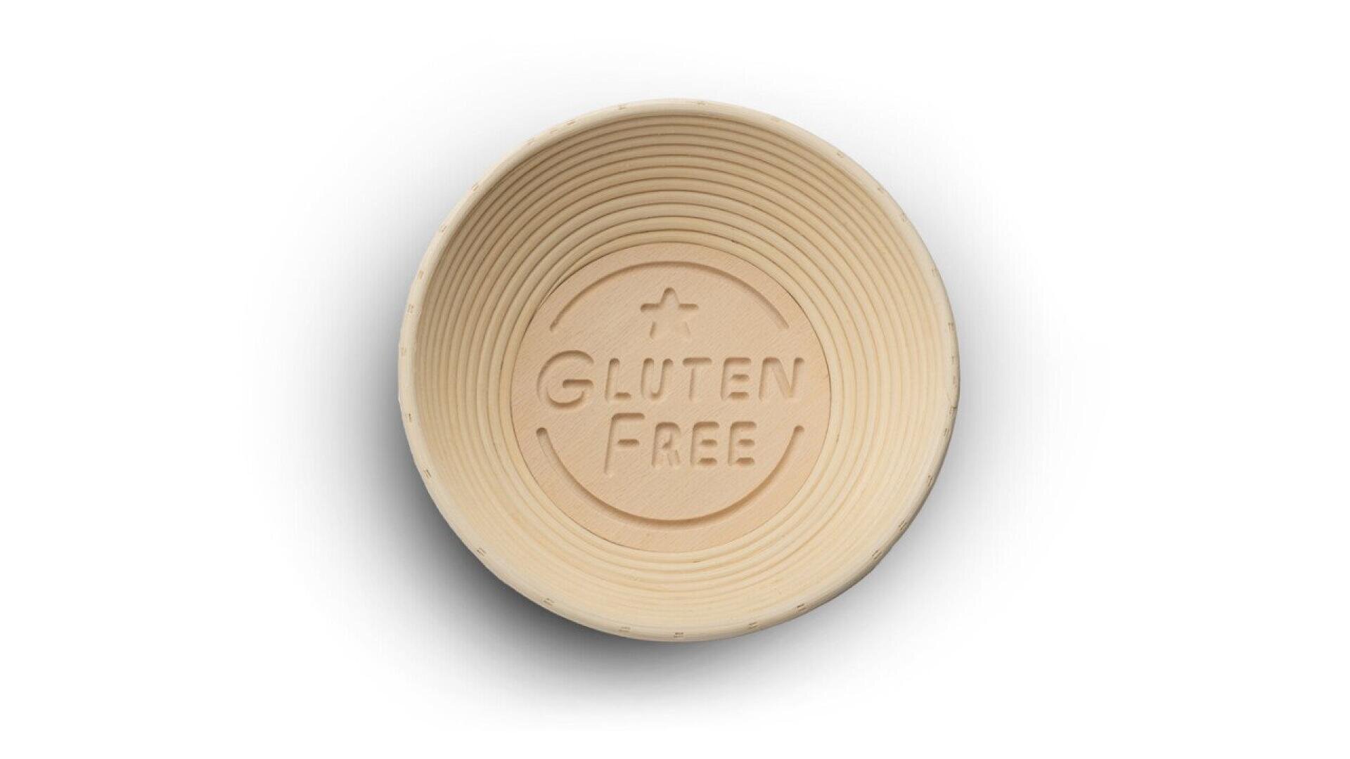 A round, light-colored bowl with the words GLUTEN FREE embossed on the bottom, seen from above on a white background.