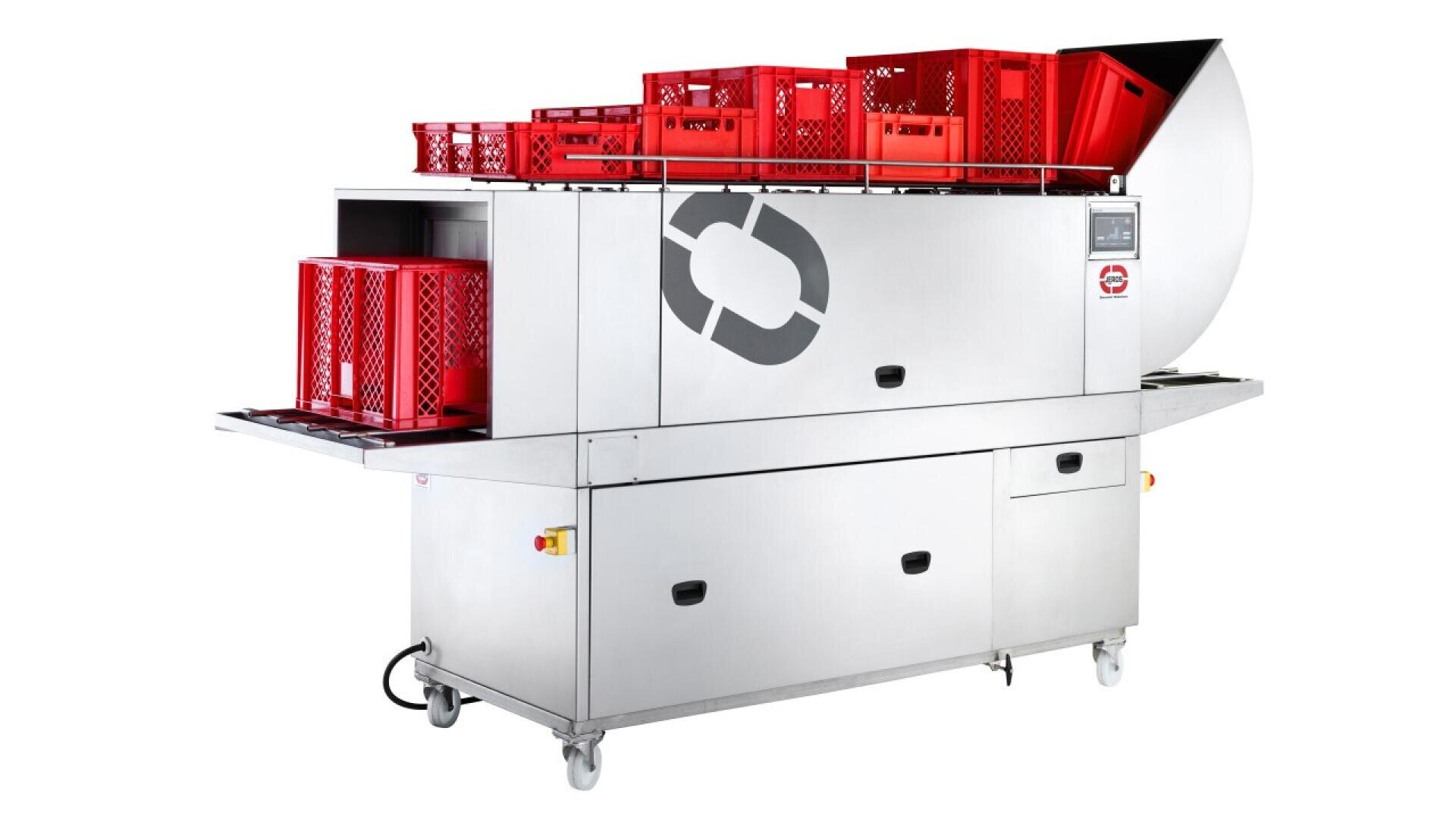 A large industrial dishwashing machine with a stainless steel body and wheels, loaded with multiple red plastic crates on the top and side trays, set against a plain white background.