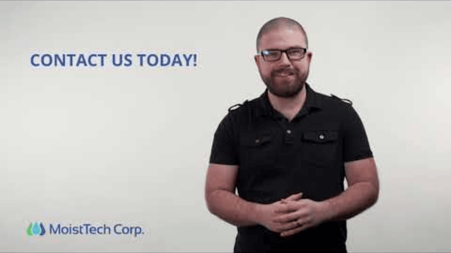 A bearded man wearing glasses and a black shirt stands smiling in front of a plain background with the text CONTACT US TODAY! and the MoistTech Corp. logo.
