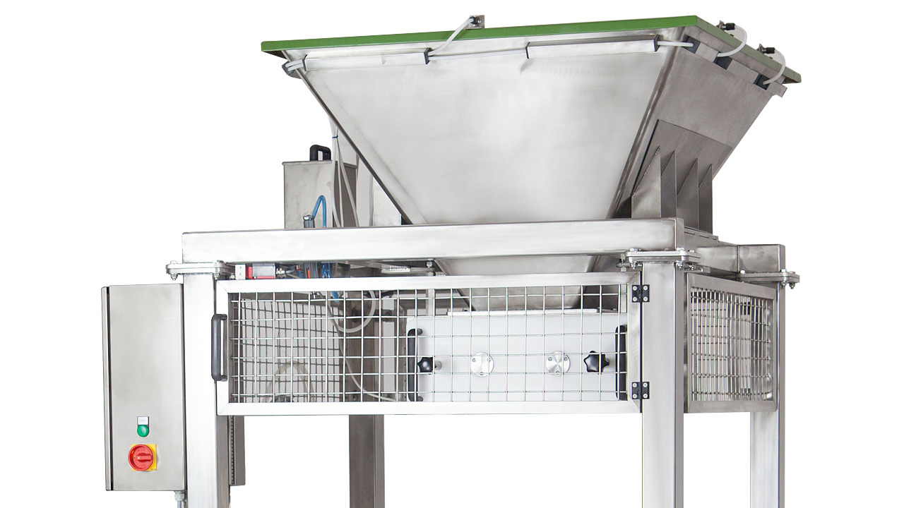 A stainless steel industrial hopper with a green lid, control panel, and safety mesh guard, designed for processing or handling bulk materials in a factory setting.
