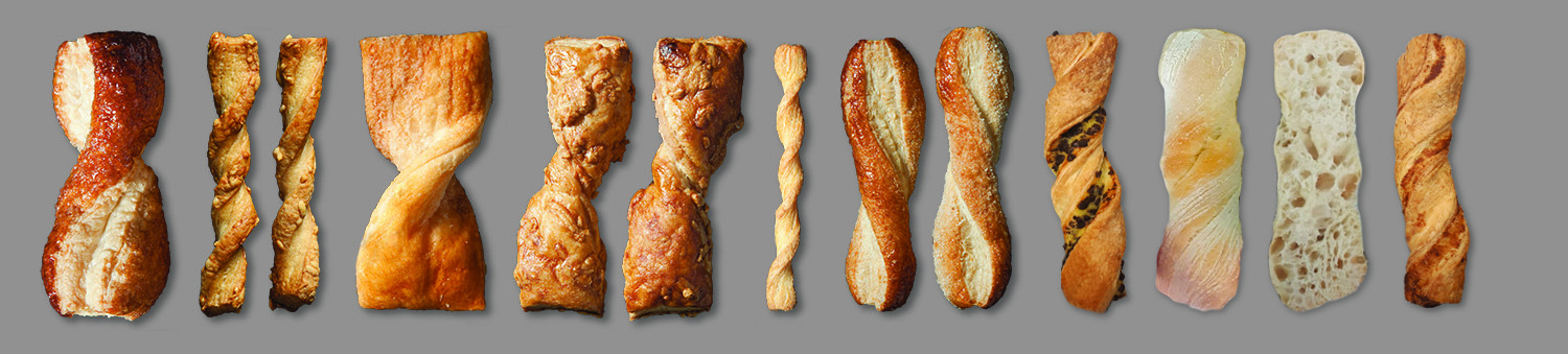 A row of fifteen assorted breadsticks and pastries, each with a different shape, twist, and texture, arranged vertically against a plain gray background.