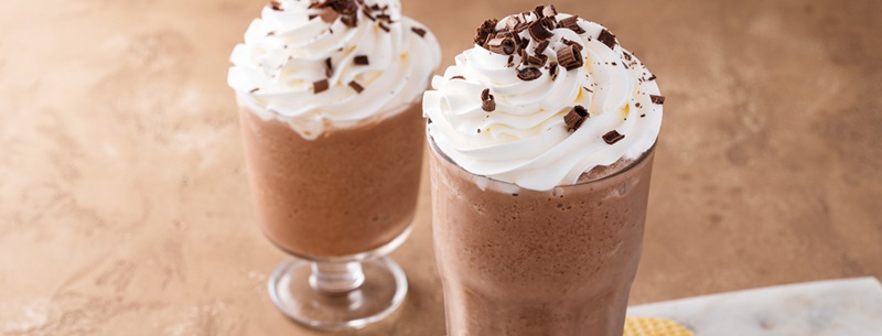 Mocha coffee frappe topped with whipped cream and chocolate curls