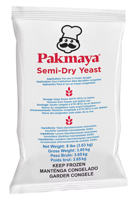 A white Pakmaya Semi-Dry Yeast package with red and blue text, a chef logo at the top, usage instructions, ingredients, and storage directions in English, French, and Spanish. KEEP FROZEN is written at the bottom.