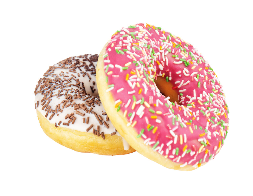 Two donuts on a white background: one with pink icing and colorful sprinkles, the other with white icing and chocolate sprinkles.